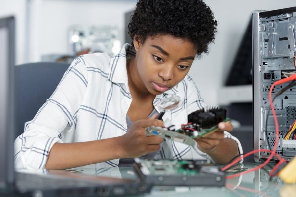 Woman fixing a computer